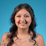 Image of Christina Colon, student smiling in a white coat