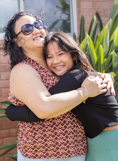 Mother and daughter hugging