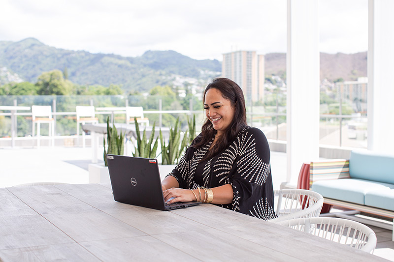 ASB teammate sitting at desk with laptop