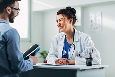 Healthcare professional with patient at desk