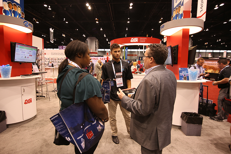 Interns chatting with Joe Haley at ASI Show