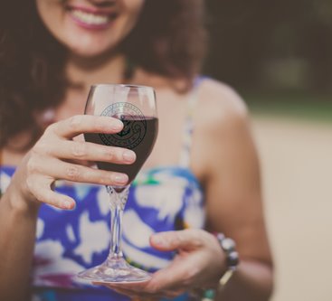 Young woman holding glass of wine