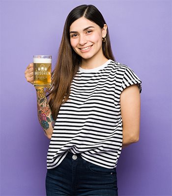 Young woman holding glass a beer mug