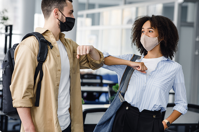 Employees elbow bumping