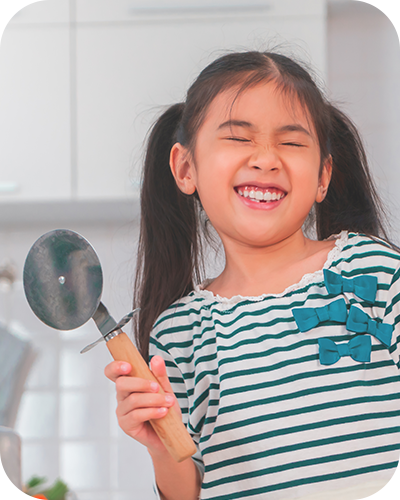 Young kid with a pizza cutter