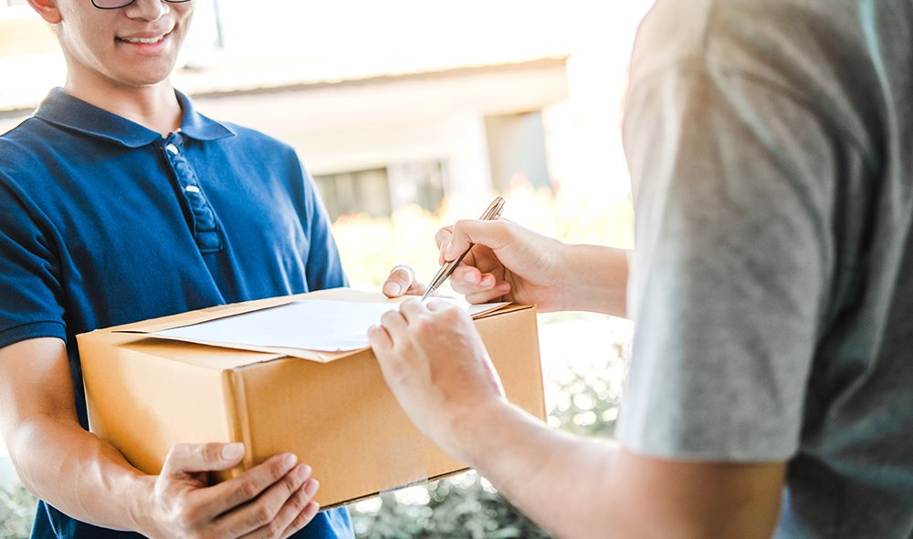 image of person signing for a delivery package