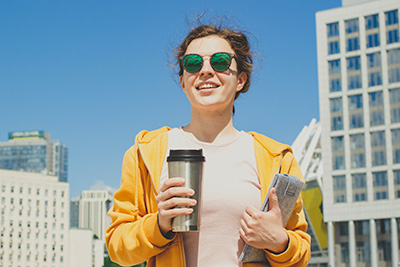 Woman holding tumbler on the go