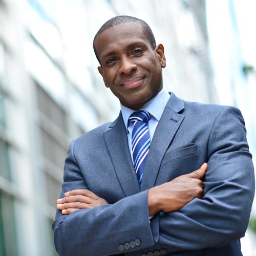 Man in business suit smiles confidently