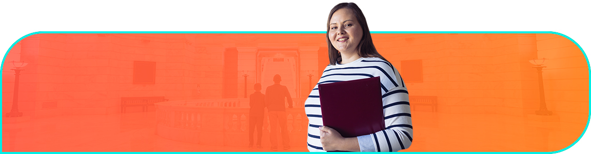 Businessperson holds a laptop and smiles