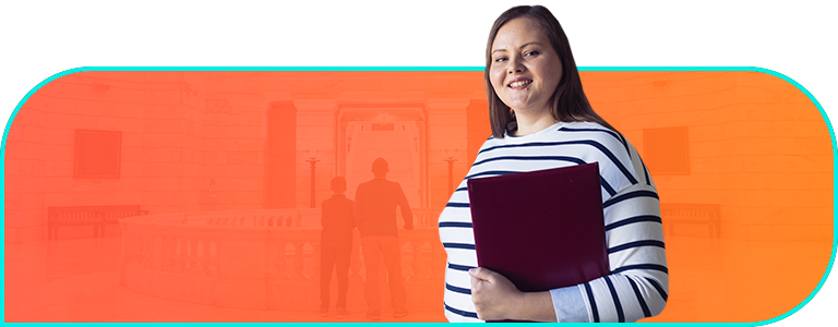 Businessperson holds a laptop and smiles