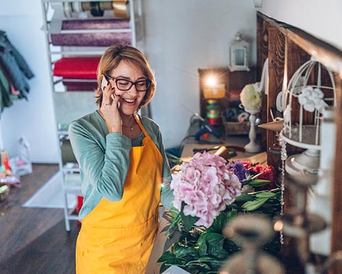 Business owner in shop, on phone