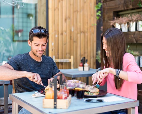 Young couple sitting at restaurant table