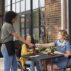 Waitress taking credit card from patron