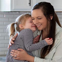 Mother holding young daughter