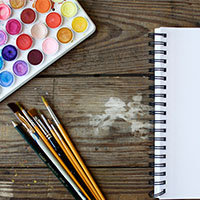 Paint tray with brushes and notebook