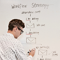 Man writing strategic plan on whiteboard