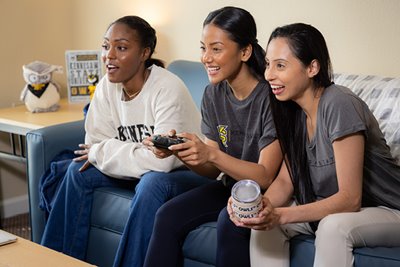 3 students playing video games together