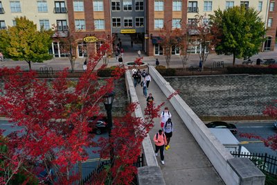 Students walking across bridge on campus
