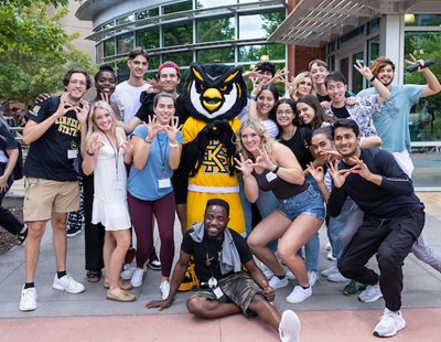 Kennesaw State Mascot Scrappy posing with a group of students